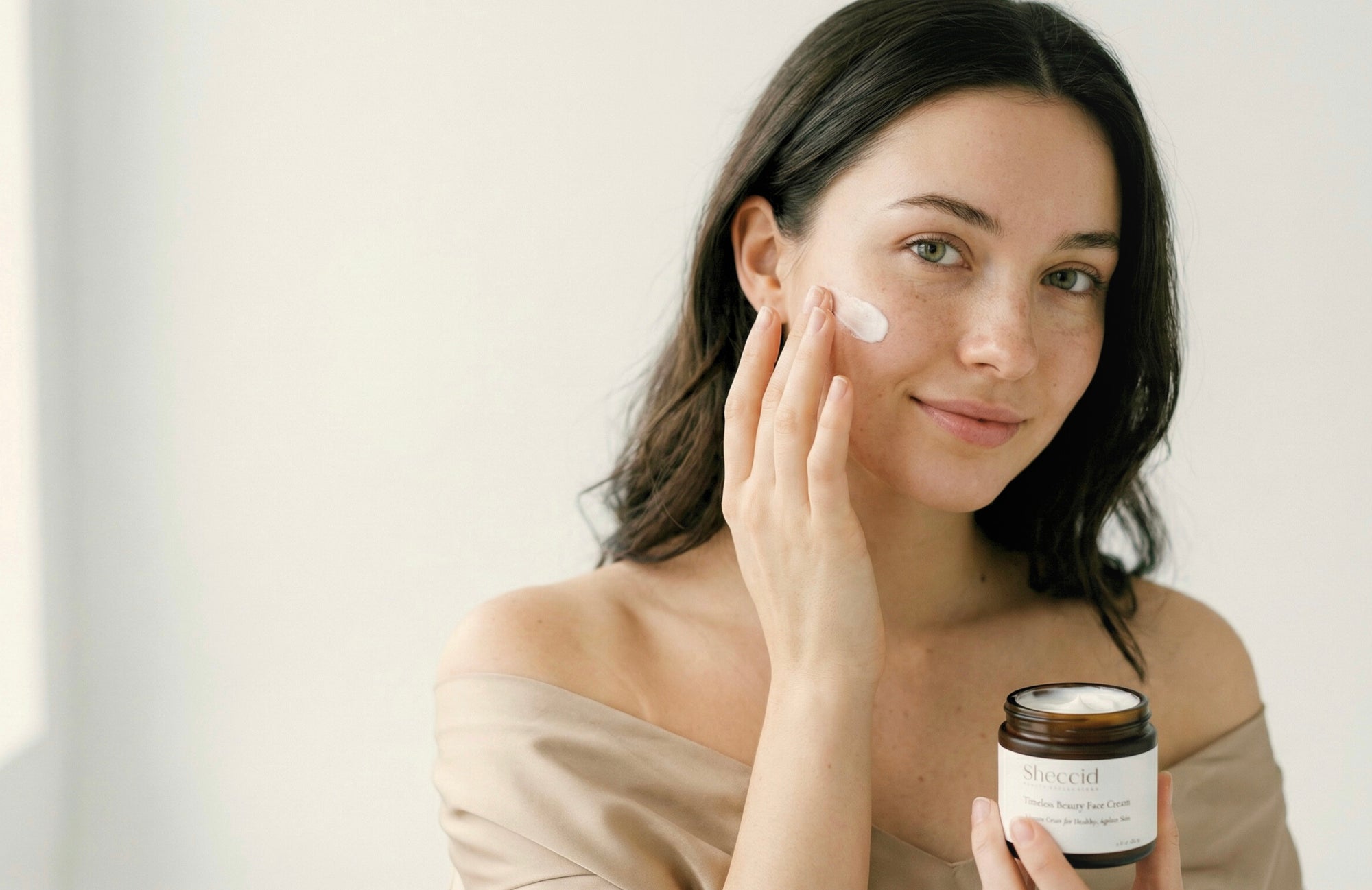 Woman applying Sheccid holistic luxury face cream as part of a clean skincare ritual